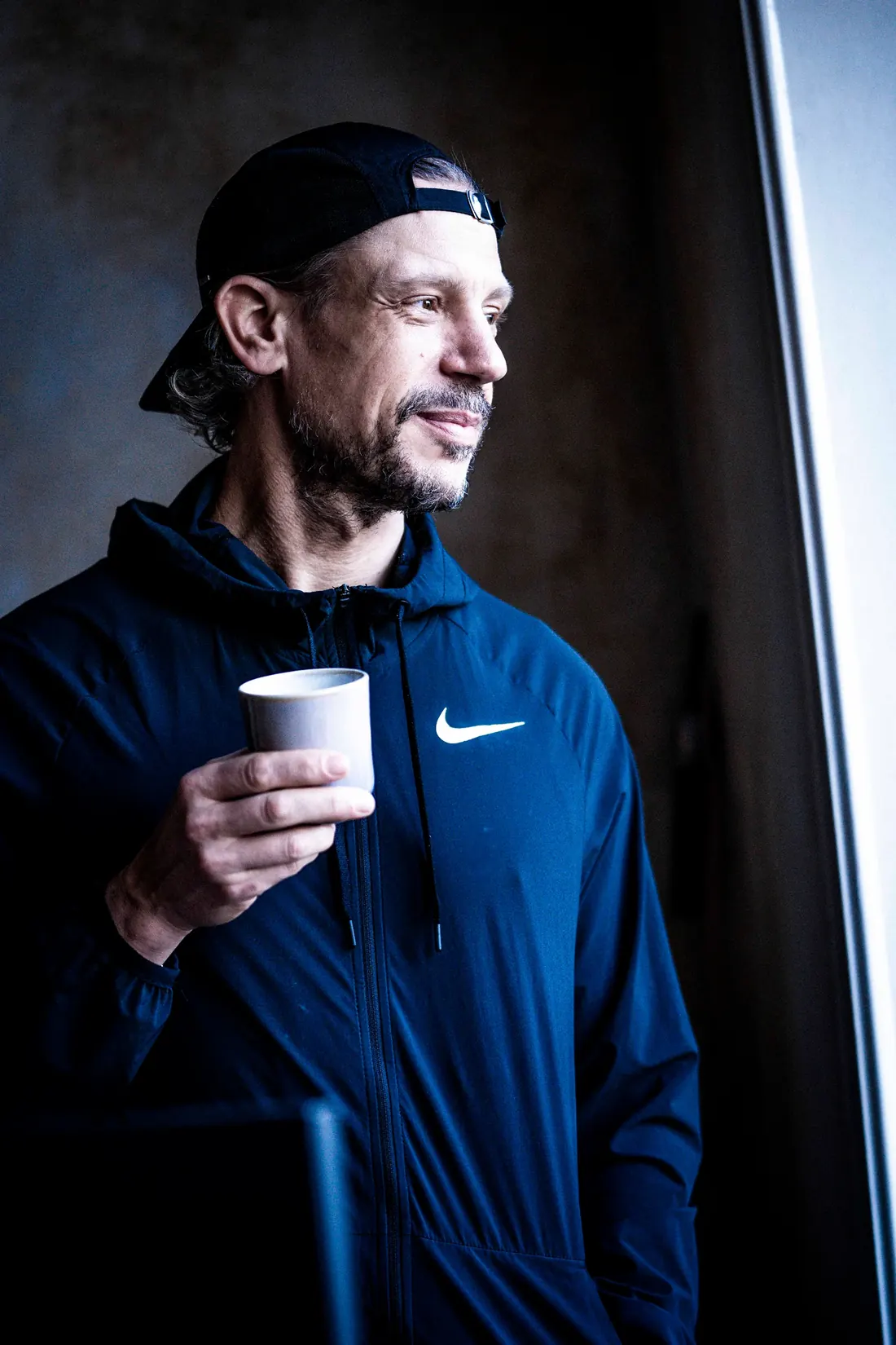 Alex with a coffee by the window