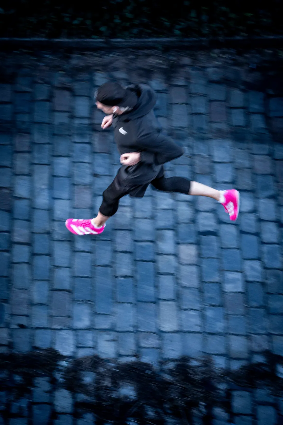 Alex jumping over cobblestones